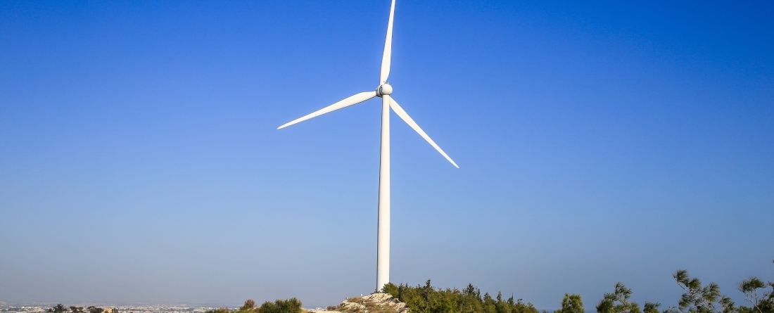 Stark white windmill against the deep blue sky of a sunny day