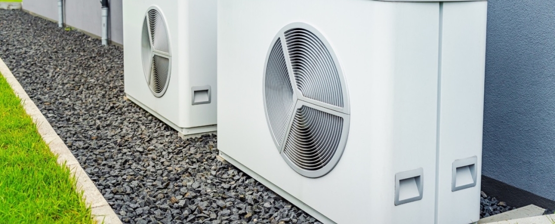 picture of heat pumps in front of a house