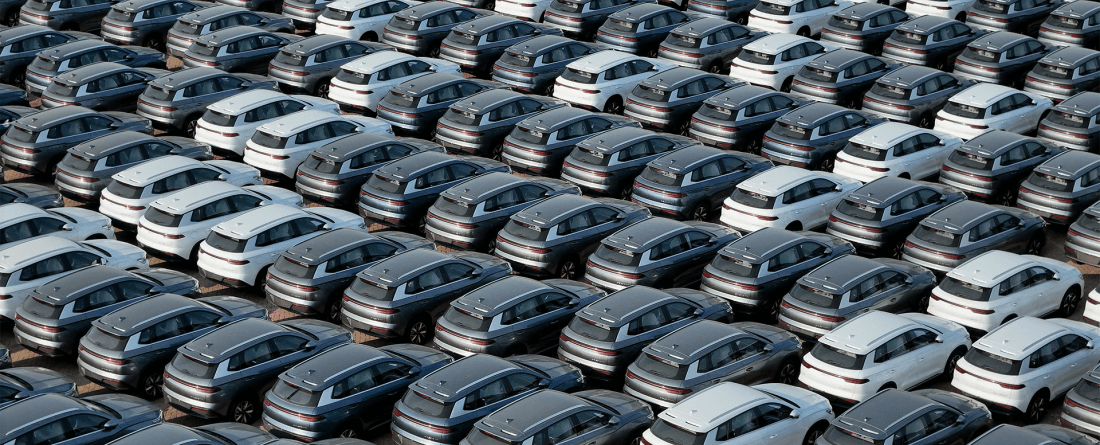 An aerial view of electric vehicles filling a large parking lot.